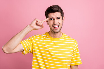 Photo of think brunet young guy point head wear yellow t-shirt isolated on pink color background