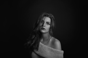 Naklejka premium Adorable young woman with long curly hair with bare shoulders