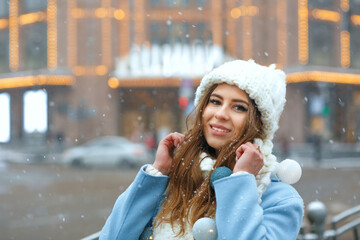 Awesome woman walking at the city decorated with garlands