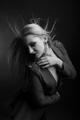 Obraz premium Sensual woman with bright makeup and hair in wind wears jacket