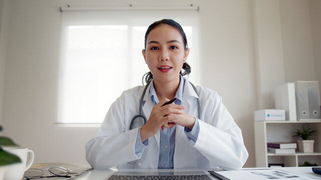 POV Screen Of Young Asia People Or Female Doctor Live Speak Talk Look At Camera Work In Online Clinic Help Patient On Digital Telehealth Telemedicine Smart Covid Consult VoIP Service App On Computer.