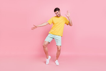 Fototapeta na wymiar Full body photo of cheerful young charming funky man dance enjoy summer isolated on pink color background
