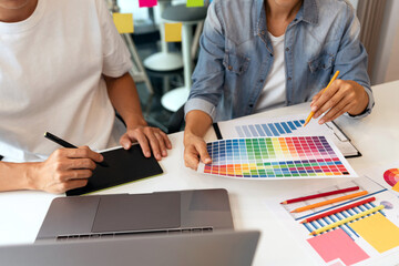 a couple of designers choosing the right colour fitting the concept from the spectrum.