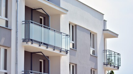 Fototapeta na wymiar Modern apartment buildings on a sunny day with a blue sky. Facade of a modern apartment building. Glass surface with sunlight.