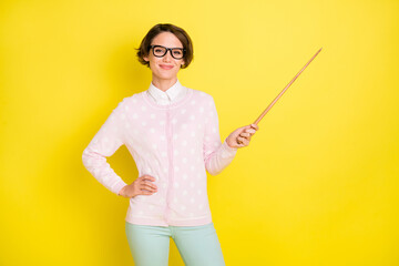 Photo portrait of girl in glasses pointing on blackboard at school teaching isolated bright yellow color background