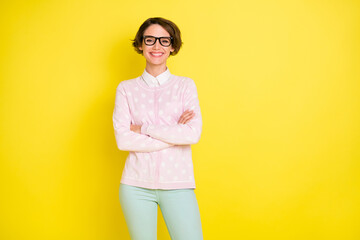 Fototapeta na wymiar Photo of charming positive young lady folded hands nice smile happy student isolated on funky yellow color background