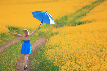 girl with an umbrella in a summer field of flowers, country female nature yellow field