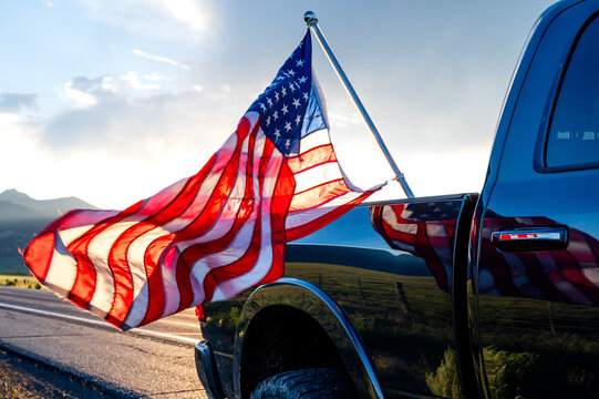 USA flag sticking from the black pickup truck cargo in Bridgeport, California, USA