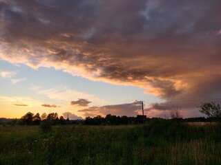 Fototapeta na wymiar dramatic sunset over the summer field