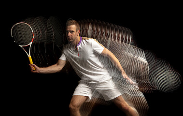 Portrait of young man, male tennis player in motion and action isolated on dark background....