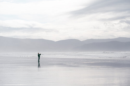 Man taking pictures on Beach in Dingle Peninsula, Ireland