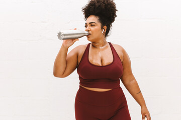 Fototapeta na wymiar Healthy female drinking water after workout