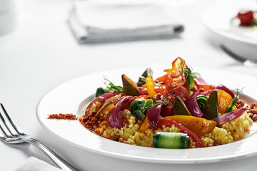 Polenta with stewed vegetables on a light plate, corn grits dish with vegetable stew, traditional...