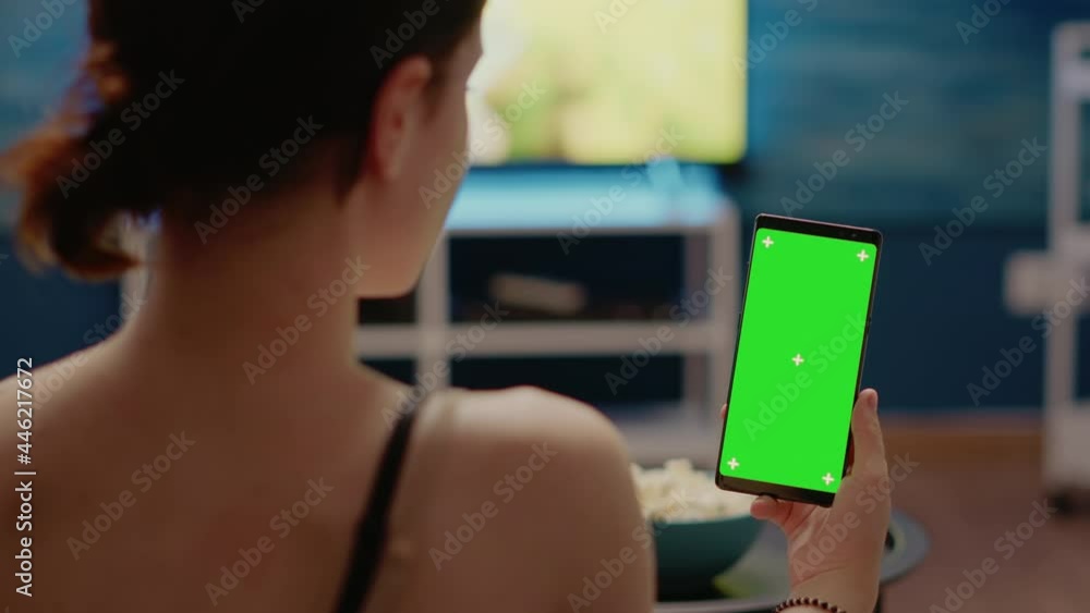 Poster young person with vertical green screen display on smartphone looking at isolated background media f
