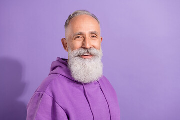 Portrait of attractive cheerful content grey-haired man wearing cozy jumper copy space isolated over purple violet color background