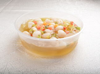 chilled cold jelly pudding with fresh lychee and mixed cocktail fruit on top in party bento tray box for asian take away dessert halal menu