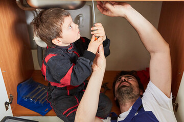 Boy helps his father as a handyman