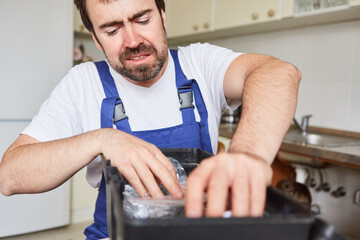 Stressed craftsman from the emergency service in the kitchen