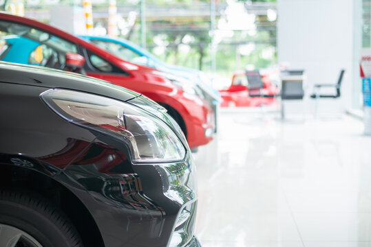 Modern beautiful showroom with cars being sold, White floor for new car parking, new car pictures in the showroom, park, show waiting for sales of branch dealers and new car service centers.