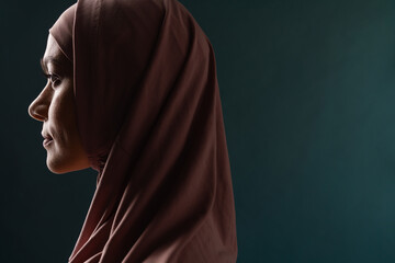 Young muslim woman wearing hijab posing in profile
