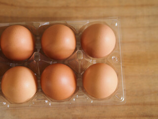 Fresh chicken eggs on wooden background. 
