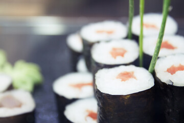 Assorted sushi food on a black slate plate