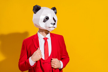 Photo of handsome panda confident pose wear mask head red tuxedo isolated on yellow color background