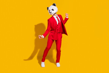 Photo of cheerful carefree panda guy dance wear mask red suit tie footwear isolated on yellow color...