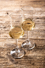 Italian golden grappa drink on wooden background