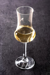 Italian golden grappa drink on black  background