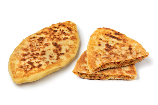 Fresh baked whole and half Moroccan stuffed batbot isolated on white background 