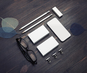 Blank corporate identity. Blank business cards, smartphone, pencils, eraser, glasses and skeletons of leaves.