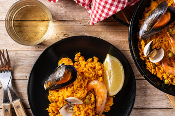 Traditional spanish seafood paella on wooden table