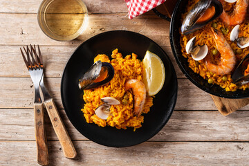 Traditional spanish seafood paella on wooden table