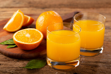 Glass with orange juice on the table.