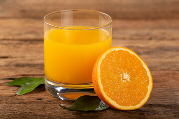 Naklejka na ściany i meble Glass with orange juice on the table.
