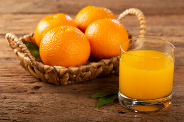 Glass with orange juice on the table.