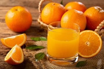 Glass with orange juice on the table.