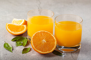 Glass with orange juice on the table.