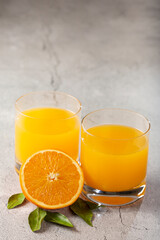 Glass with orange juice on the table.