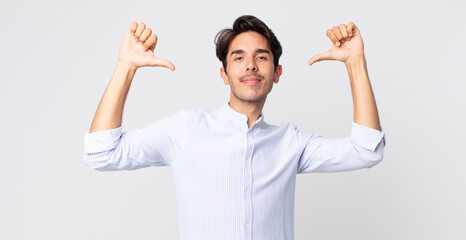 hispanic handsome man feeling proud, arrogant and confident, looking satisfied and successful,...