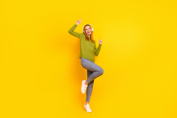 Fototapeta na wymiar Full length body size photo dancing in headphones girl in casual clothes isolated vibrant yellow color background