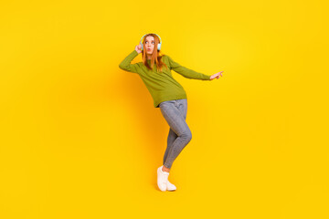 Fototapeta na wymiar Full length body size photo dancing in earphones girl in casual outfit isolated vibrant yellow color background