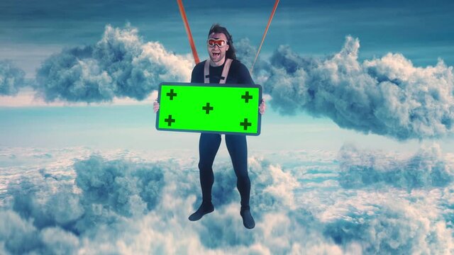 Excited parachutist with chromakey banner