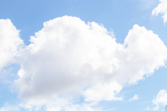 Sky blue and white big hunk lump cloud obscuring the sun beautiful with bright sunlight nature background. panorama.