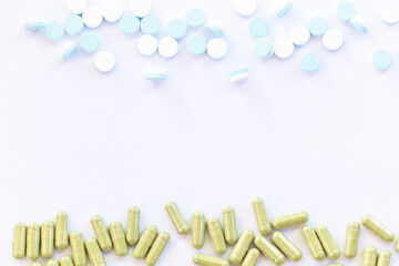 Oral medicine, paracetamol acetaminophen pill medication. Andrographis Paniculata capsules arranged on one side (Herbal capsules) on a white background.Thai herbal against coronavirus (COVID-19).