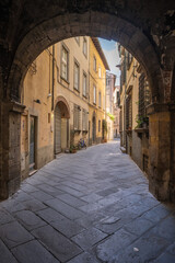 Old empty narrow street of Lucca in Tuscany Italy