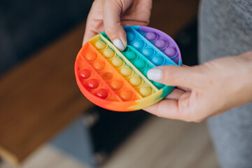 Woman holding pop it toy, close up