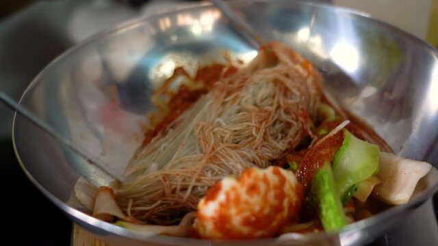Korean cold noodles; naengmyeon. Sliced cucumber, pickled radish. savory food
