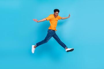 Fototapeta na wymiar Full length body size view of attractive cheerful crazy guy jumping walking fooling having fun isolated over bright blue color background